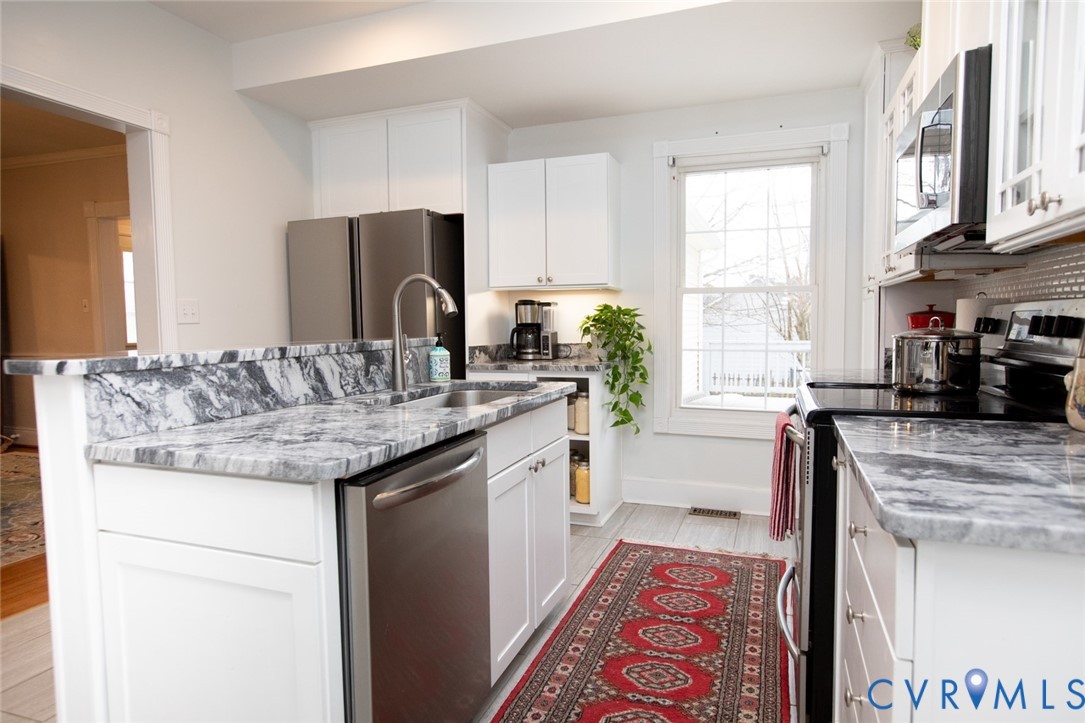 401 2nd Avenue Farmville, VA 23901 - Photo 26 of 55 a kitchen with stainless steel appliances granite countertop a sink stove and refrigerator