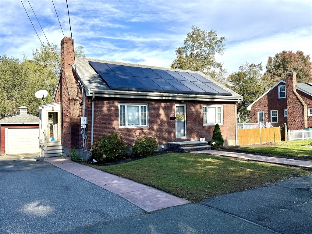 a view of a house with a yard and plants