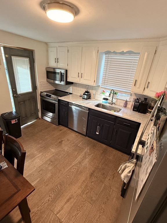 68 Sutcliffe Road Lynn, MA 01904 - Photo 11 of 23 a kitchen with stainless steel appliances granite countertop a stove a sink and a refrigerator