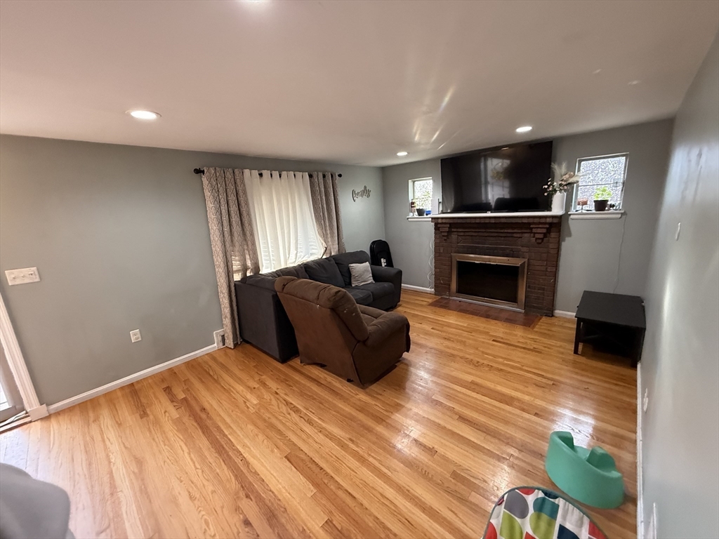 68 Sutcliffe Road Lynn, MA 01904 - Photo 12 of 23 a living room with furniture and a fireplace
