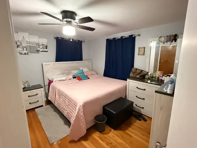 a bedroom with furniture and flat screen tv
