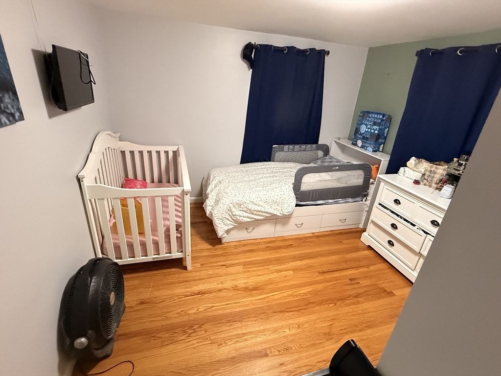 68 Sutcliffe Road Lynn, MA 01904 - Photo 16 of 23 a bedroom with furniture and flat screen tv