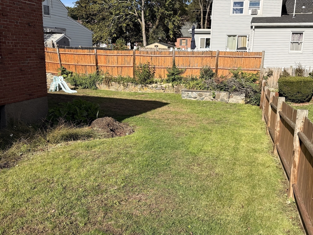 68 Sutcliffe Road Lynn, MA 01904 - Photo 5 of 23 a view of a swimming pool with a bench and trees in the background