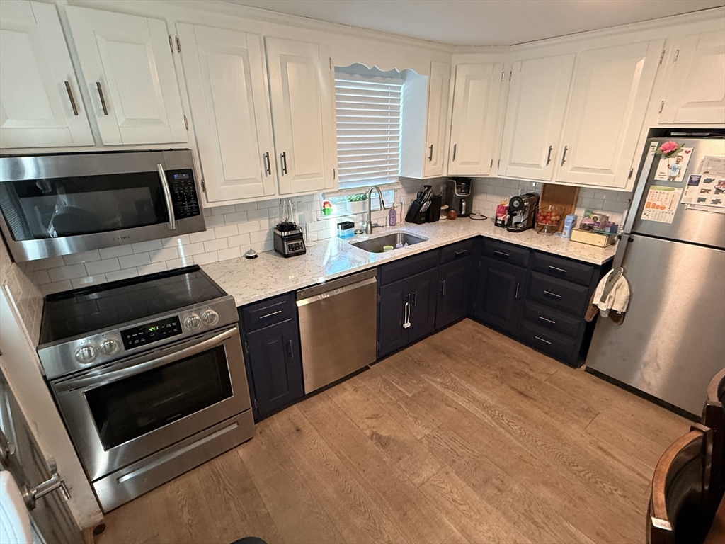 68 Sutcliffe Road Lynn, MA 01904 - Photo 10 of 23 a kitchen with a stove and white cabinets