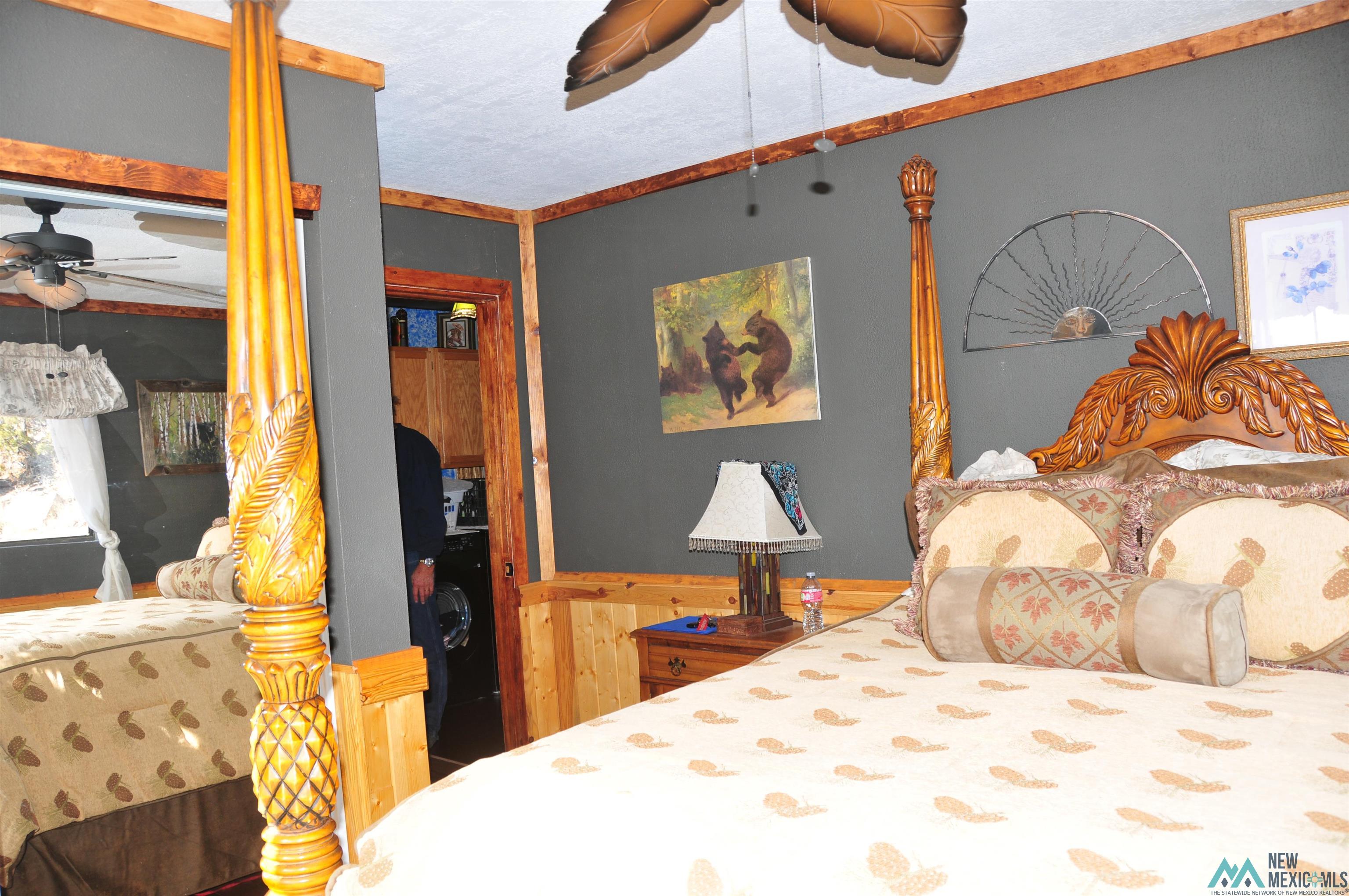 25 Bluff Road Thoreau, NM 87323 - Photo 14 of 31 Wood-paneled walls with dark gray upper wall sections and wood trim