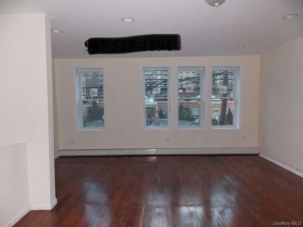 439 Forbell Street Brooklyn, NY 11208 - Photo 6 of 8 a view of wooden floor and windows in a room