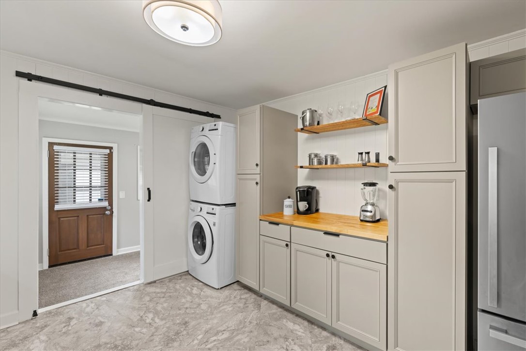 174 Holliday Road Six Mile, SC 29682 - Photo 16 of 49 A clever and modern laundry solution, combining stacked appliances with custom cabinetry and a barn door entry