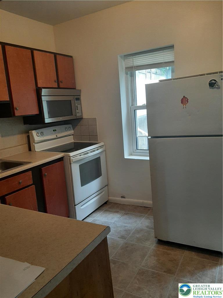 824 East 8th Street Bethlehem, PA 18015 - Photo 2 of 10 a kitchen with a refrigerator and a stove top oven