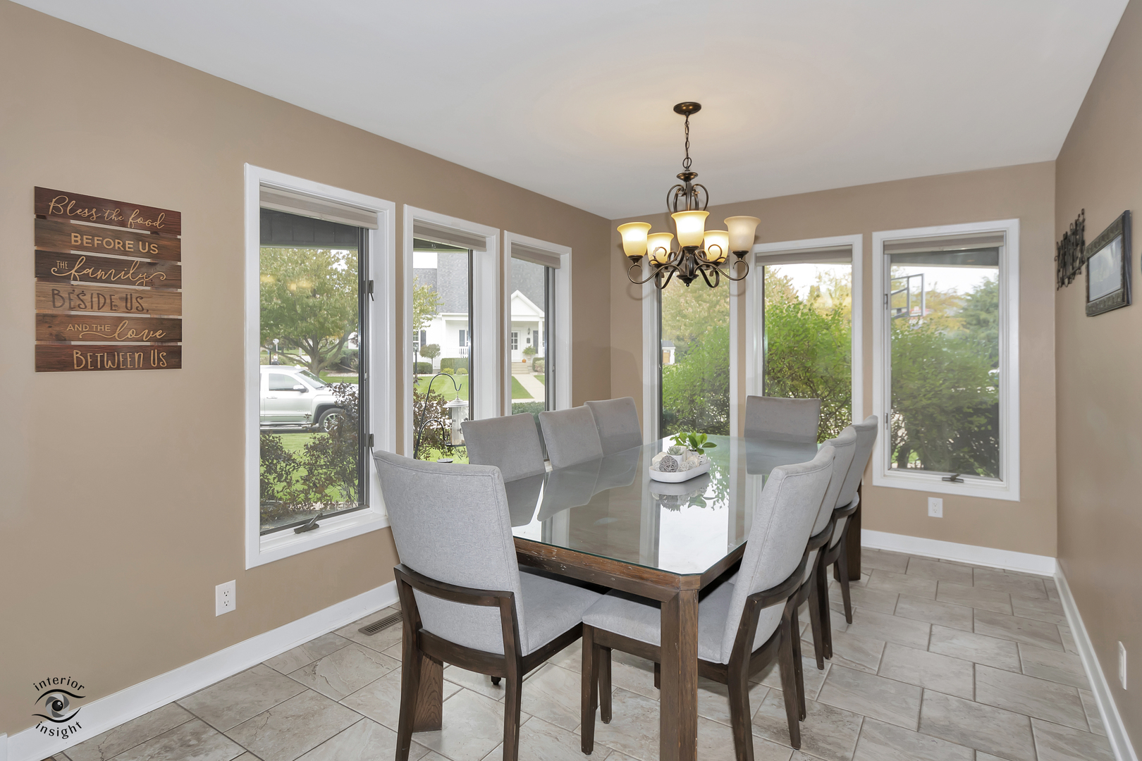 1560 Southhampton Drive Bourbonnais, IL 60914 - Photo 6 of 28 a dining room with furniture large windows and a chandelier