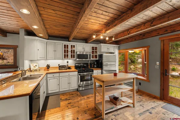 a kitchen with a stove sink and cabinets