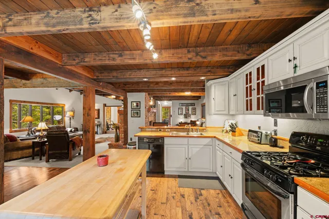 a view of a room with wooden floor and furniture