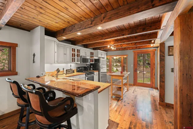 a dining room with furniture a rug and wooden floor
