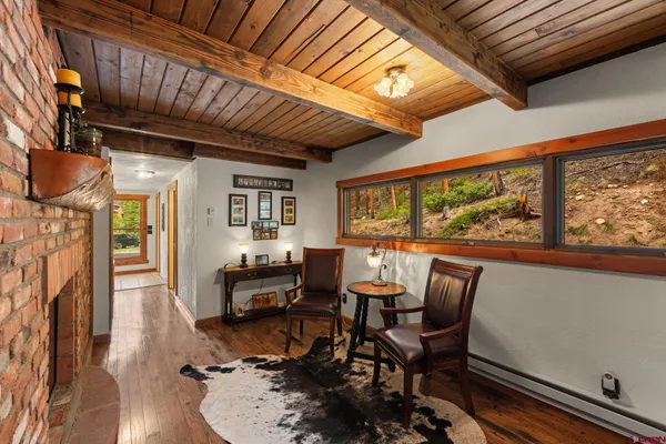 a livingroom with furniture a fireplace and wooden floor