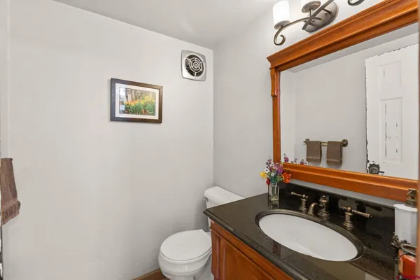a view of a hallway with wooden floor and windows