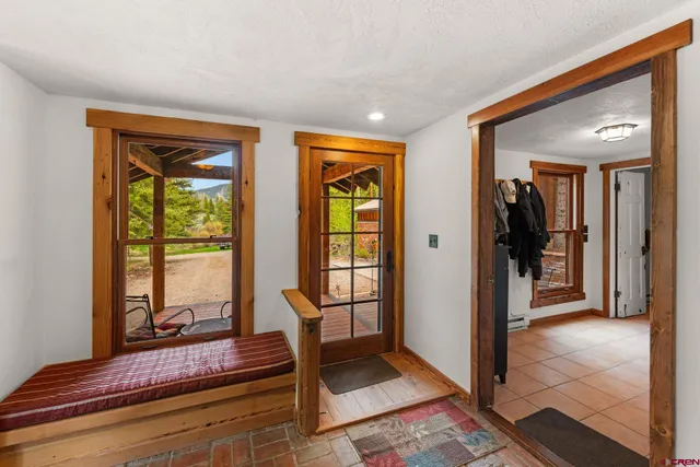 a living room with furniture and large windows