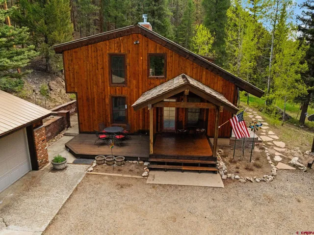 a living room with furniture a fireplace and city view