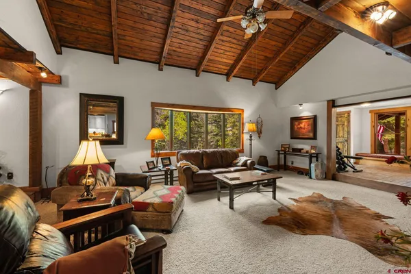 a living room with patio furniture and a flat screen tv