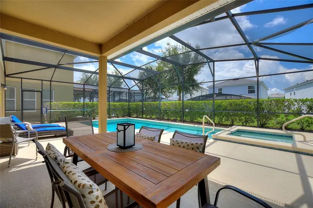 a view of a yard with table and chairs under an umbrella