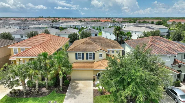 an aerial view of a house with a yard