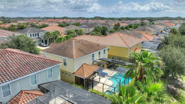 an aerial view of a house with a garden and lake view