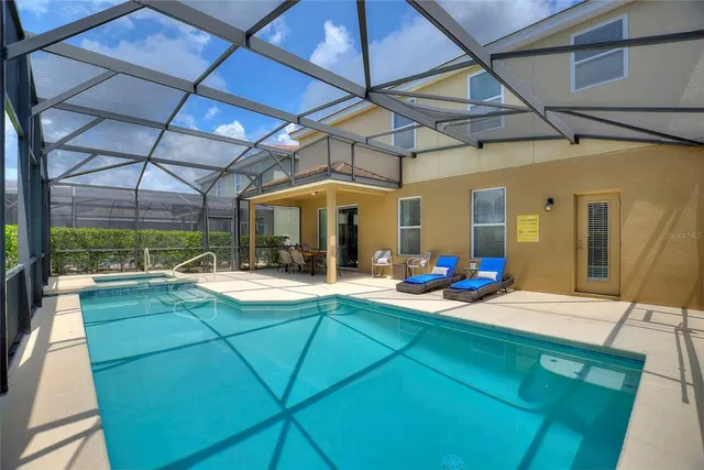 a view of a dining room with furniture and chandelier