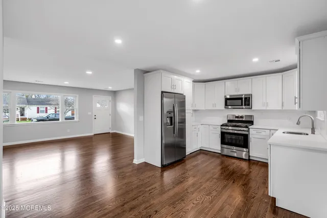 a view of a refrigerator in kitchen and wooden floor