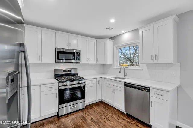 a kitchen with a sink stove and refrigerator