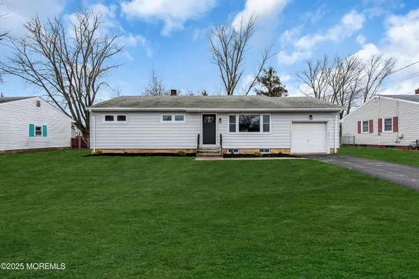 a front view of house with yard and green space