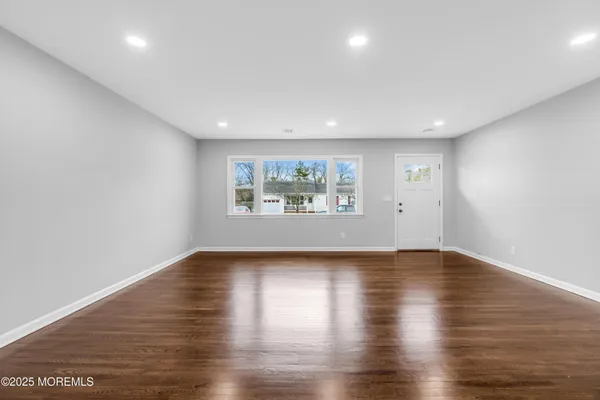 a view of empty room with wooden ceiling