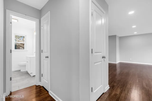 a view of a hallway with wooden floor