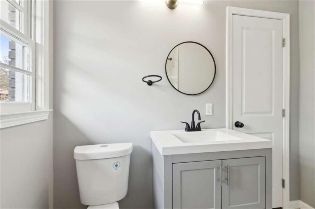 269 Elks Street Winder, GA 30680 - Photo 35 of 42 a bathroom with a toilet sink and mirror