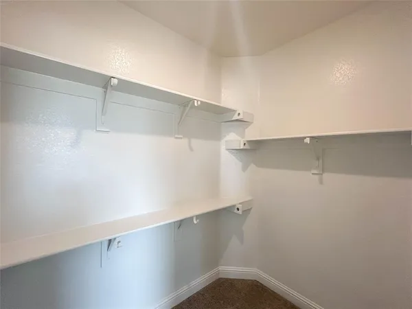 an empty room and window in a bathroom