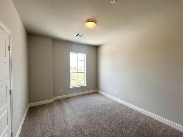 a view of an empty room and a window