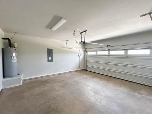 a view of a big room with ceiling fan and windows