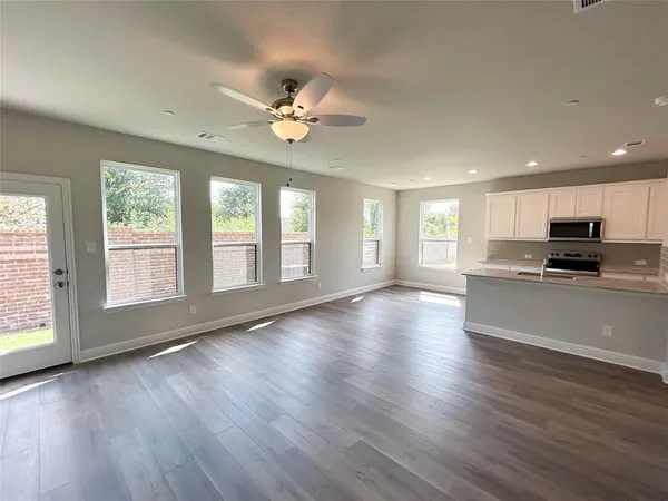 a view of kitchen with closet and wooden floor