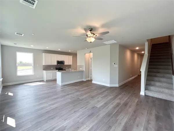 a kitchen with a sink appliances and cabinets