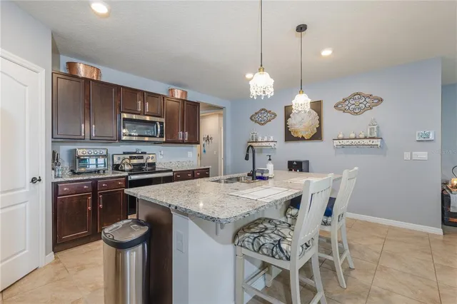 a kitchen with a dining table and chairs