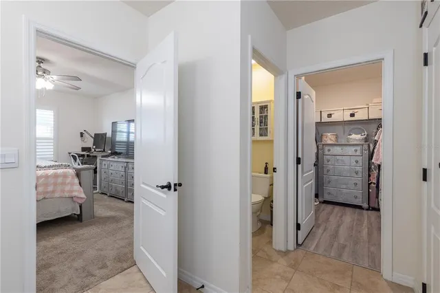 a view of a hallway with furniture and wooden floor