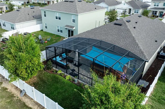 an aerial view of a house with a yard