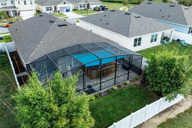 an aerial view of a house with a yard