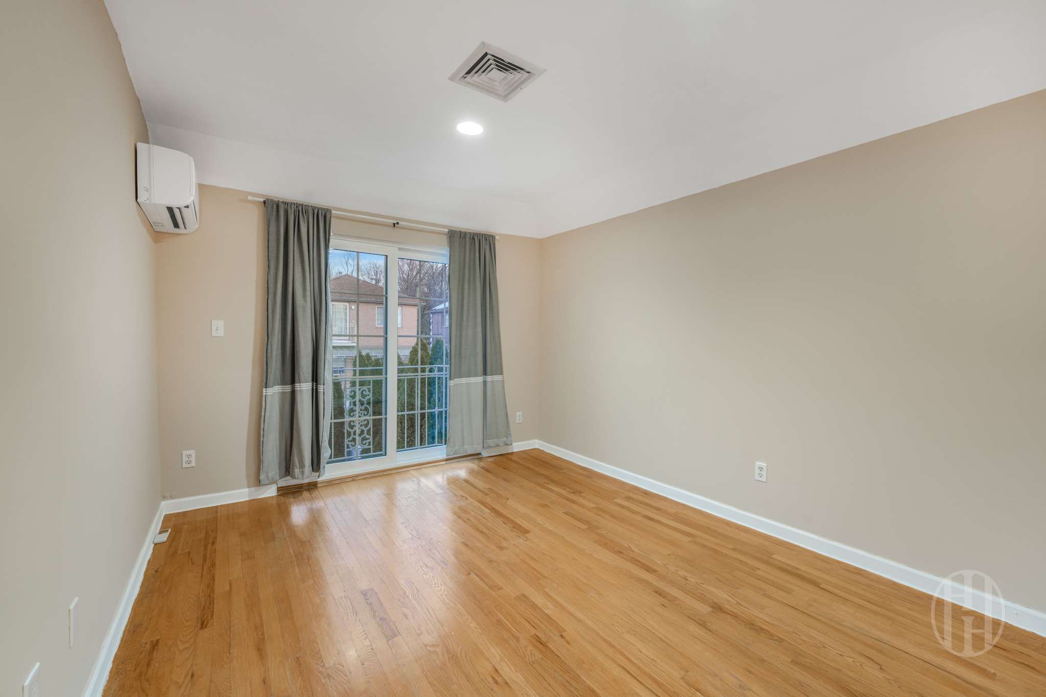 88-10 70th Road, Unit 2 Queens, NY 11375 - Photo 10 of 17 a view of an empty room with wooden floor and a window