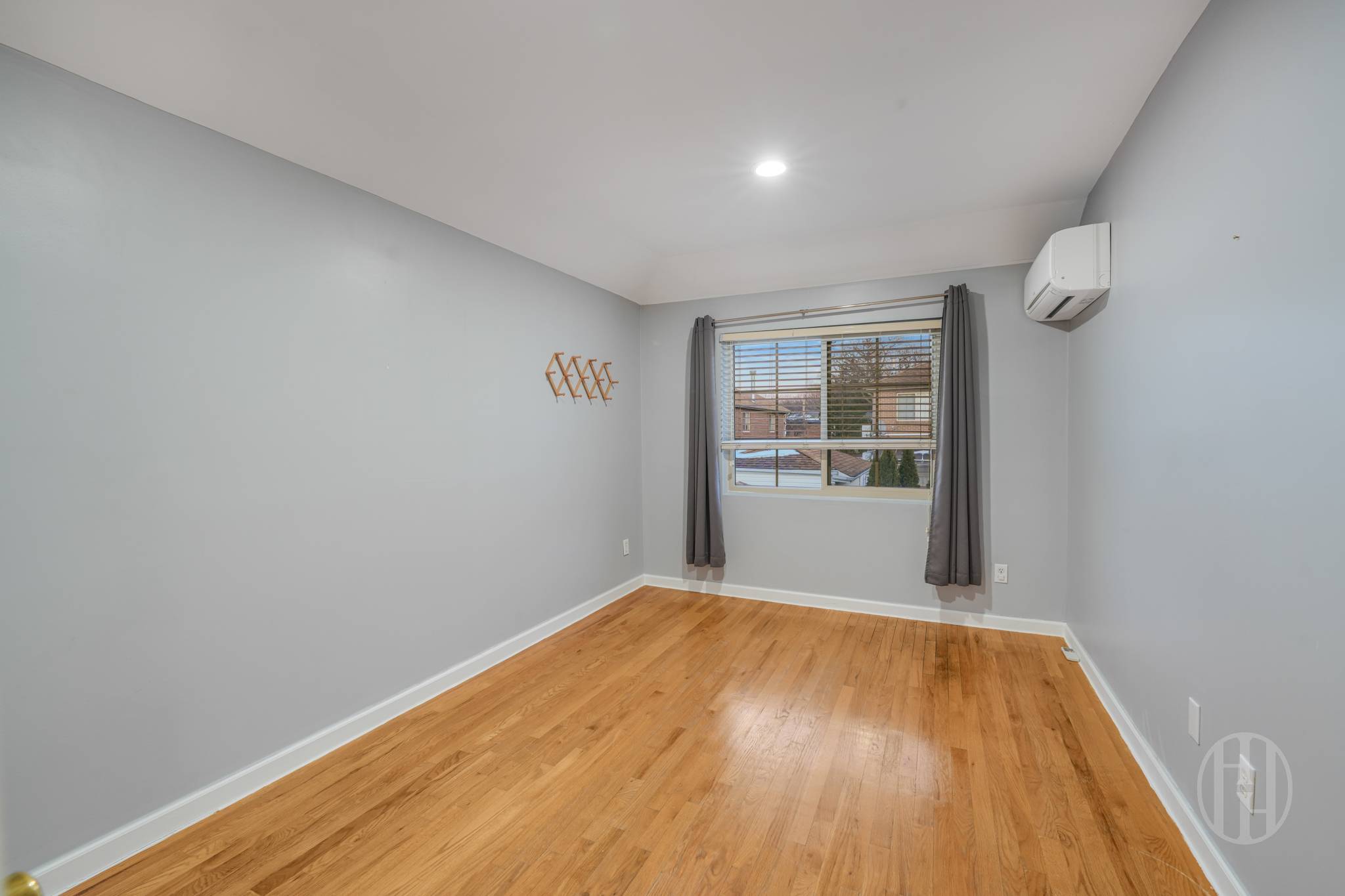 88-10 70th Road, Unit 2 Queens, NY 11375 - Photo 11 of 17 a view of an empty room with wooden floor and a window