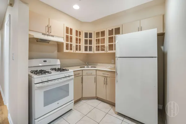 a kitchen with a stove and a refrigerator