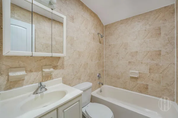 a bathroom with a sink toilet and bathtub