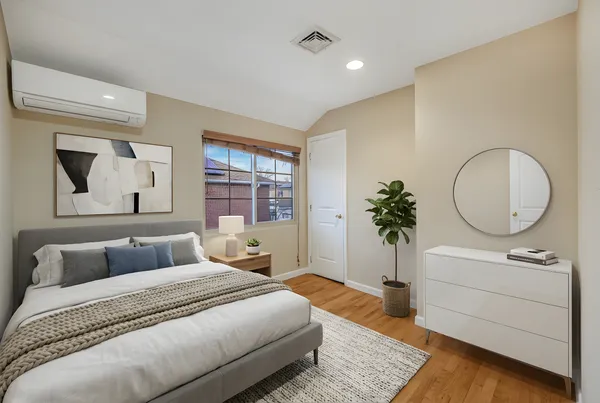 a bedroom with a bed and a couch