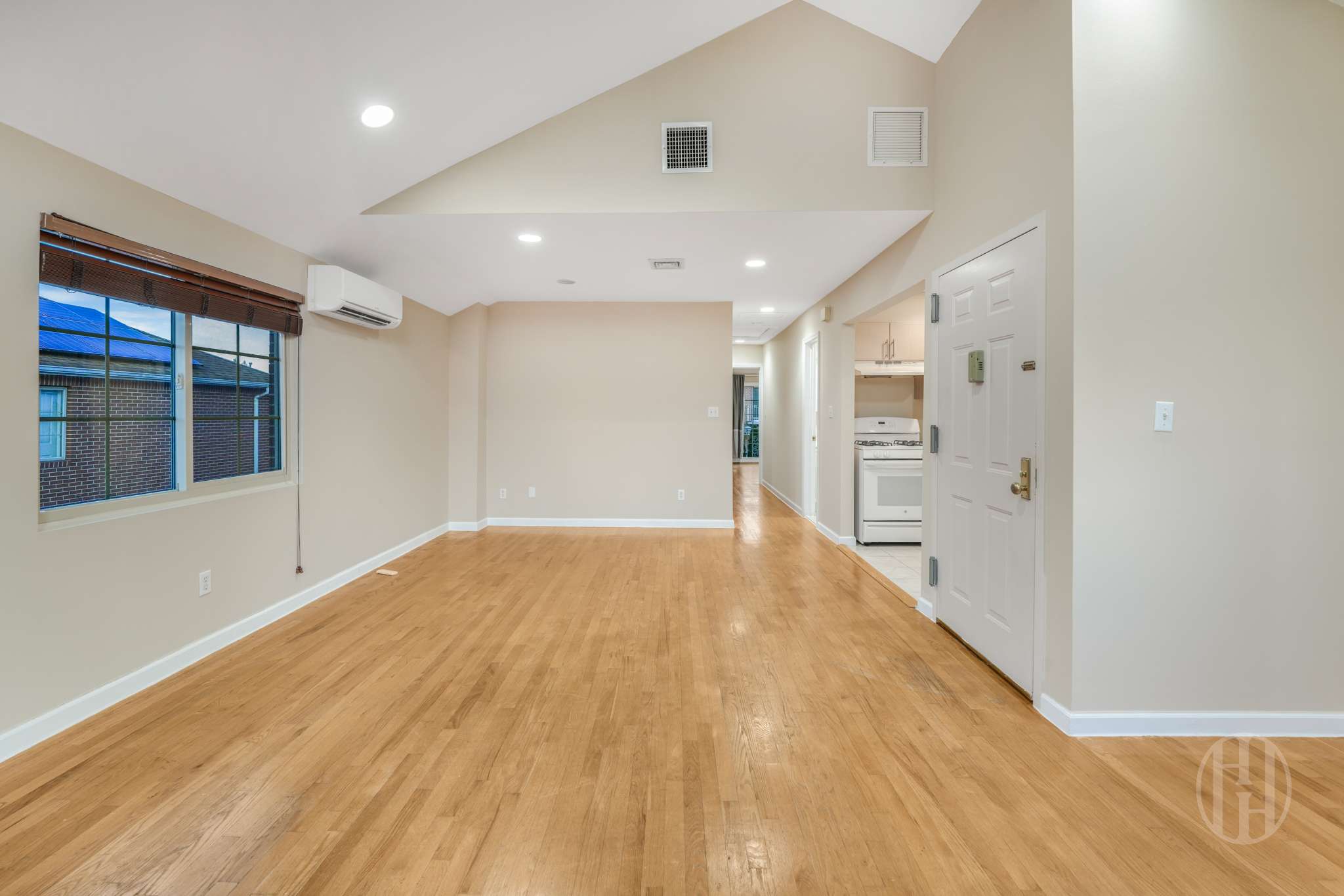 88-10 70th Road, Unit 2 Queens, NY 11375 - Photo 6 of 17 a view of an empty room with wooden floor and windows