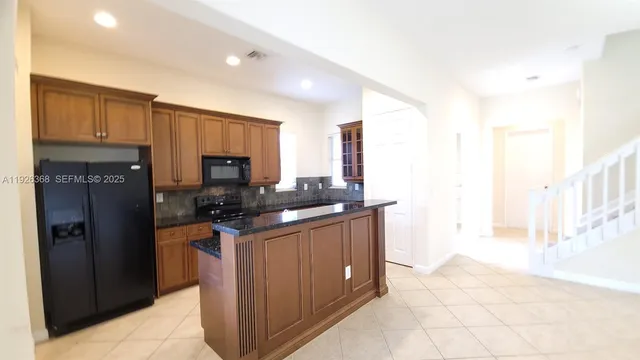 a view of a living room with furniture and a chandelier