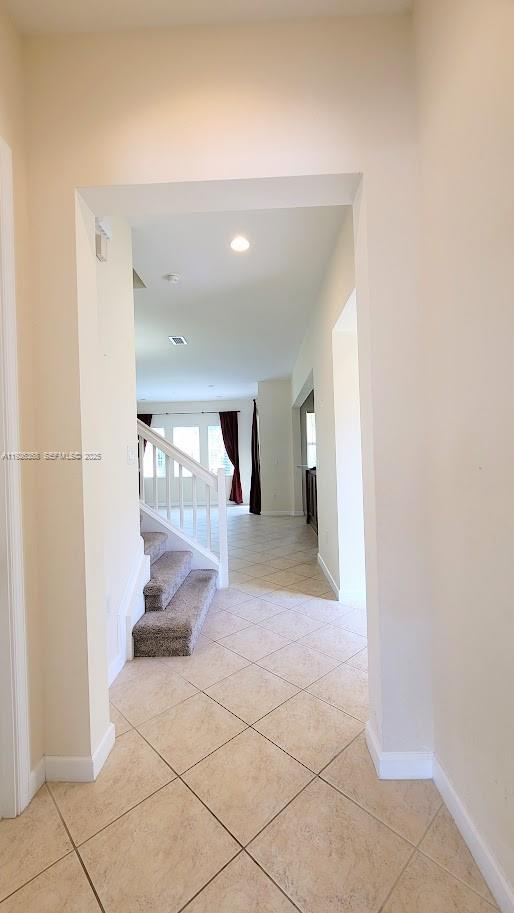 6033 Northwest 118th Drive, Unit 6033 Coral Springs, FL 33076 - Photo 16 of 43 a view of a hallway with wooden floor and a living room
