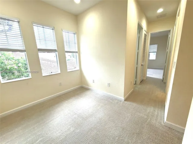 an empty room with windows and entrance