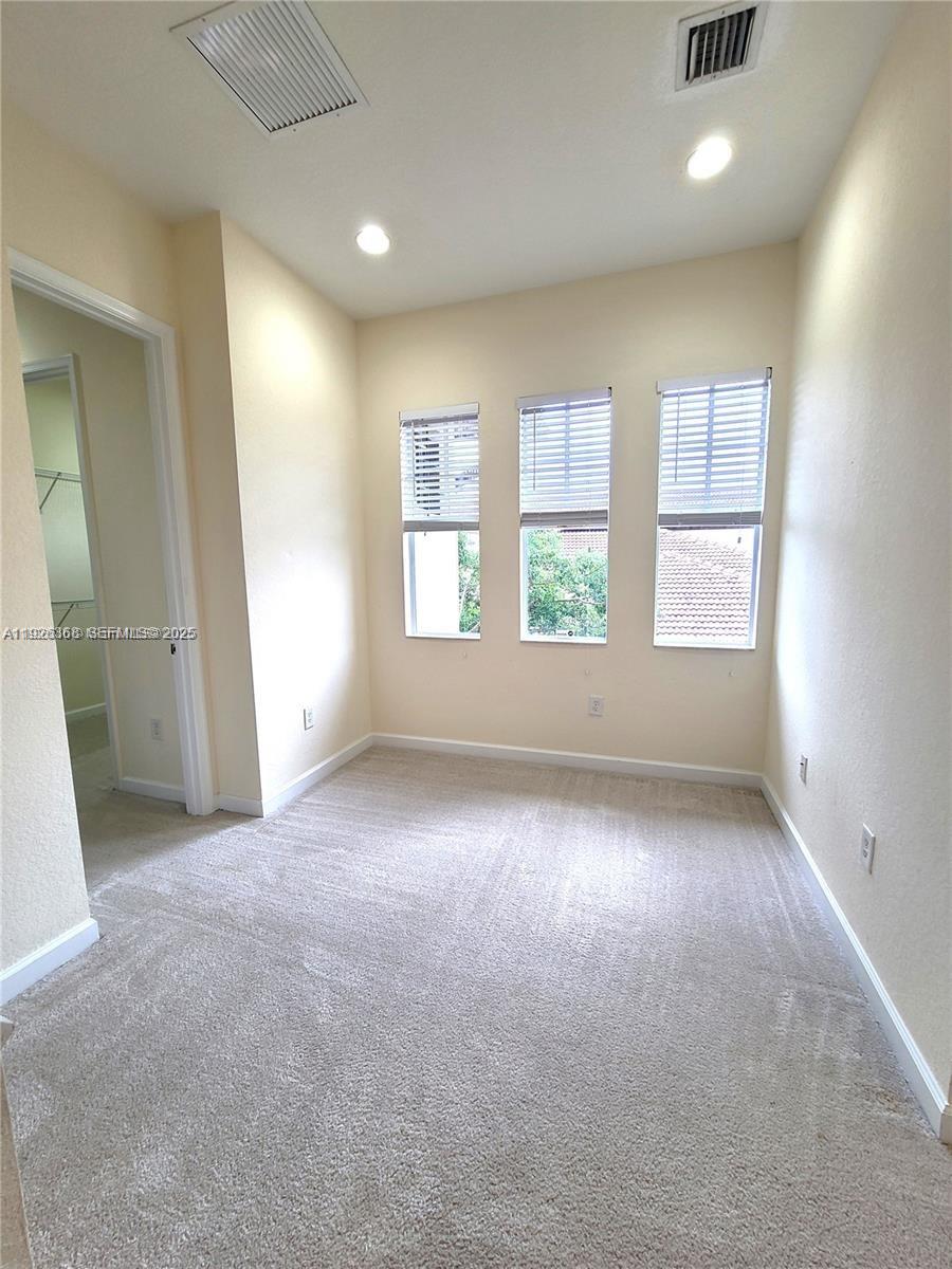 6033 Northwest 118th Drive, Unit 6033 Coral Springs, FL 33076 - Photo 20 of 43 an empty room with windows and entrance